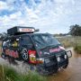 Crew crossing water in the black 'School of Rock' van during the Variety Bash