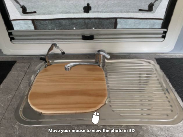 Homemade wooden sink cover providing extra benchtop space in this Highline Caravan sink