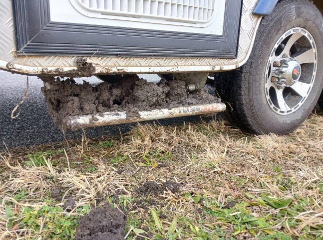 black mud on the step reveals just how close this caravan was to being bogged